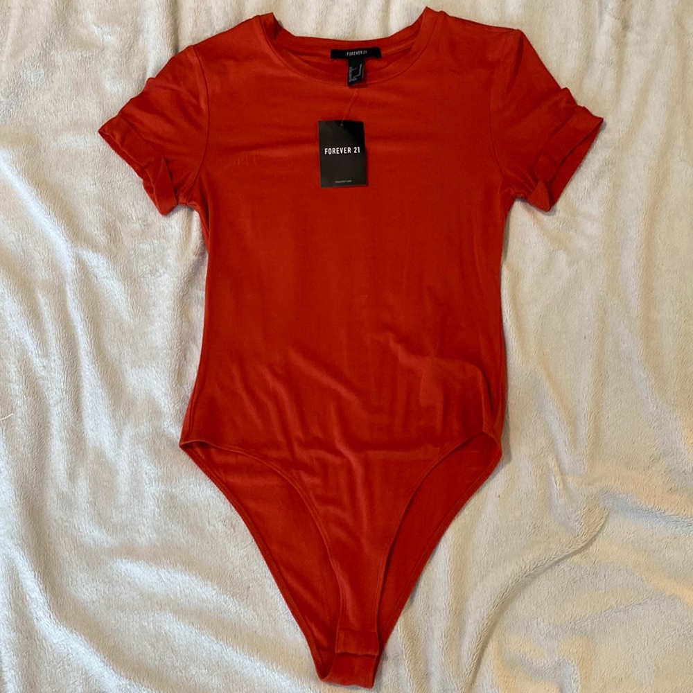 Never been worn! Forever 21 burnt orange body suit.